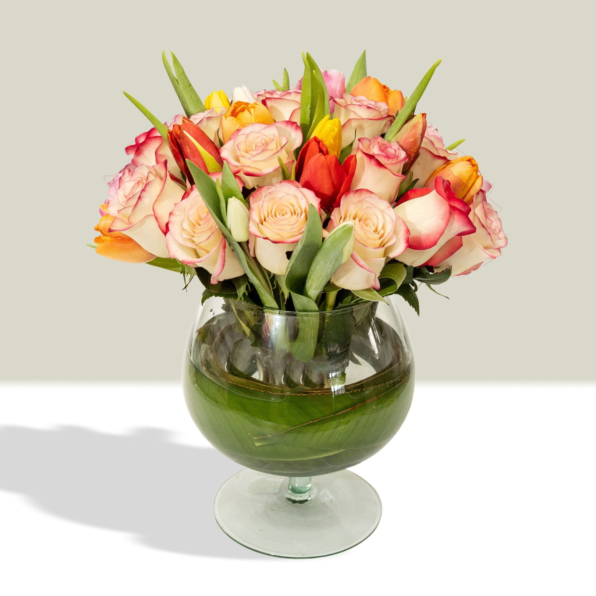 Arreglo con 20 rosas y 20 tulipanes variados en florero copón, rosas blush (crema con borde rojo)