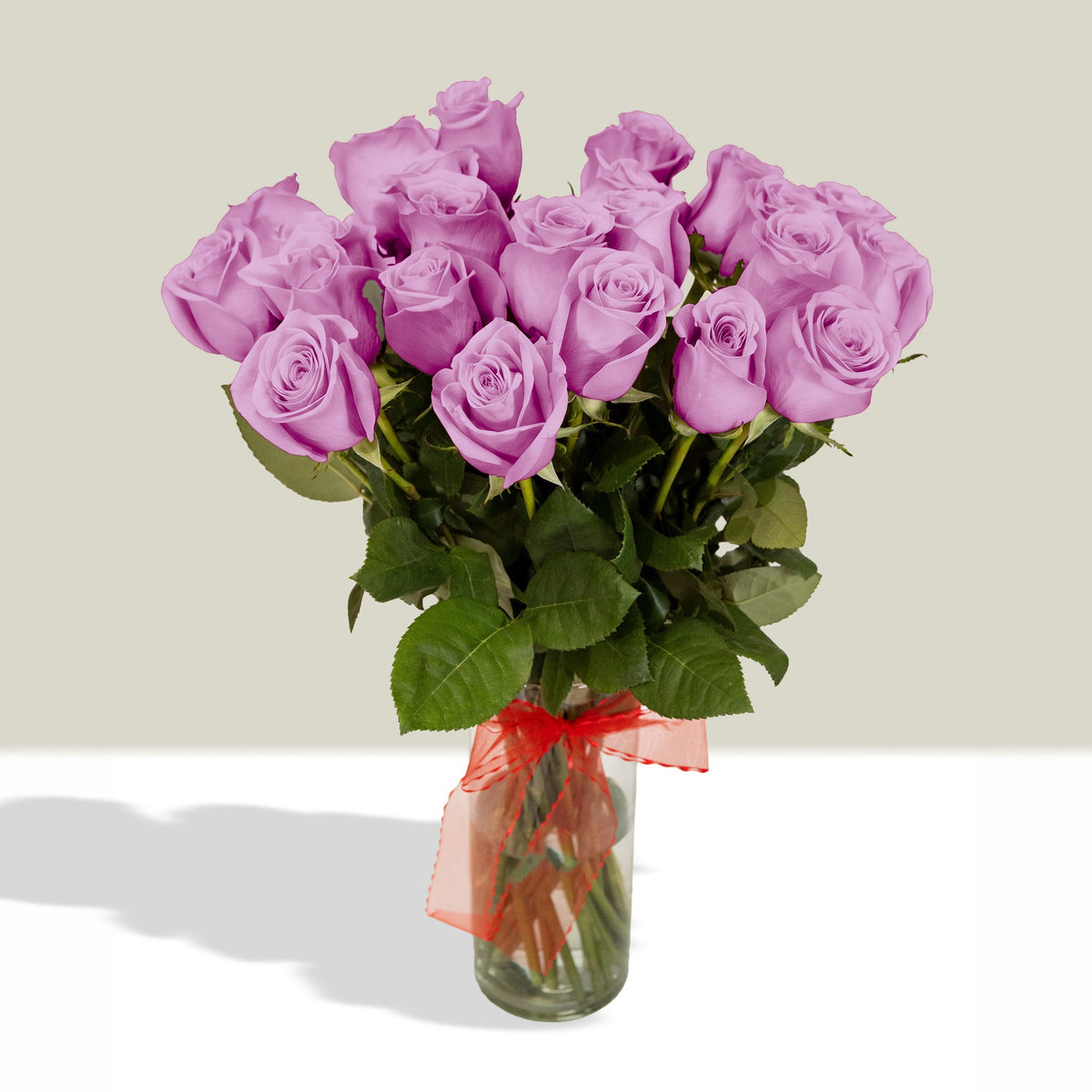 Arreglo con 24 rosas en florero velón con cinta, rosas lila